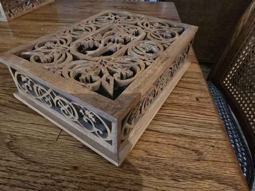 Intricately Handcrafted Wooden Box Featuring Ornate Fretwork Patterns on the Lid